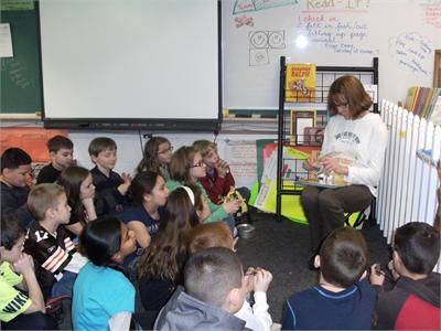 Ms. Tindera reads to Mrs. LaGruth's class